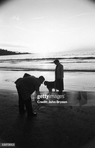 Children's author Theodor Geisel, aka Dr. Seuss, with his wife Helen and their dog at the beach.