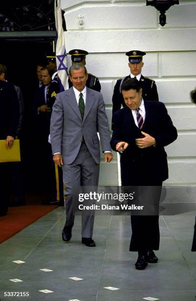 White House Chief of Staff James Baker & Caspar Weinberger look for their places during White House departure ceremony for Israeli Prime Minister...