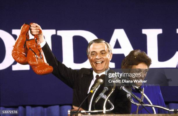 Presidential candidate Walter Mondale with wife Joan, waving red boxing gloves given to him by Mayor Washington after primary victories in Georgia &...