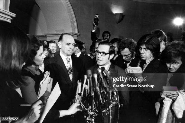 James McCord Jr. Looks on while his lawyer Bernard Fensterwald speaks to journalist Carl Bernstein and other reporters after McCord testified about...