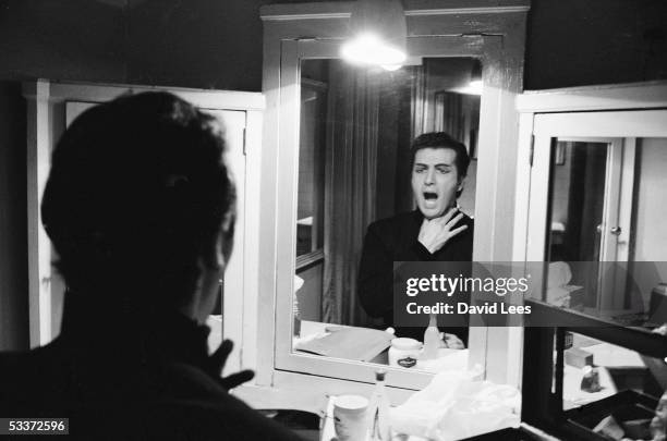 Italian opera star Franco Corelli warming up in his dressing at La Scala.