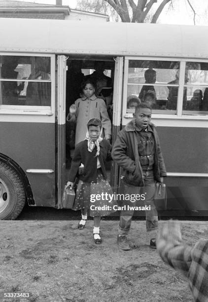 African American elementary school children getting off a bus re segregation of elementary grade schools only, prompting the famed legal suit Brown...