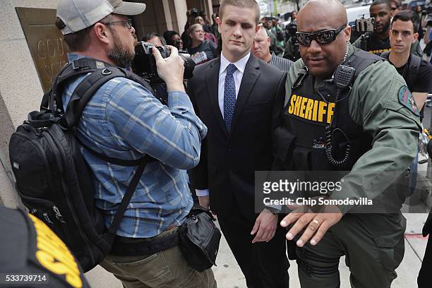Baltimore City Sheriff's Deputies clear a path for Baltimore Police Officer Edward Nero's family members as demonstrators and members of the news...