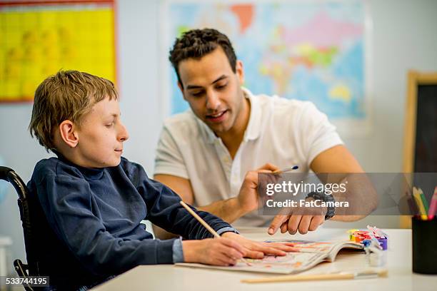 boy with developmental disability - teenager cerebral palsy stock pictures, royalty-free photos & images