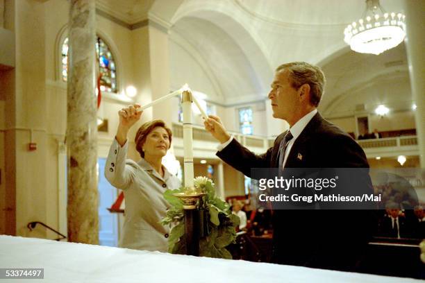 President George Bush and his wife Laura light memorial candles during private prayer service for the victims of the September 11 terrorist attacks...