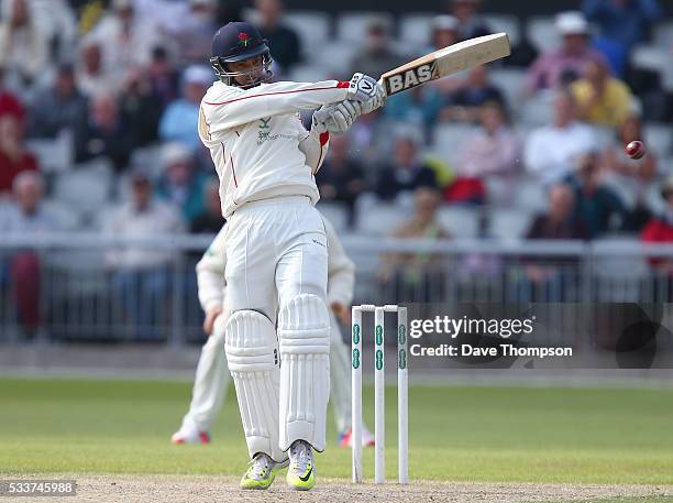 Alviro Petersen of Lancashire plays a hot for four to bring up his century during the Specsavers County Championship Division One match between...