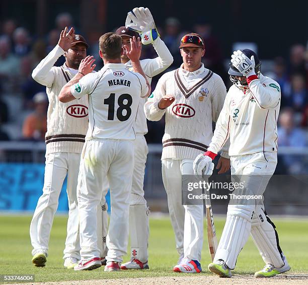 Alviro Petersen of Lancashire holds his head after being dismissed by Stuart Meaker of Surrey during the Specsavers County Championship Division One...