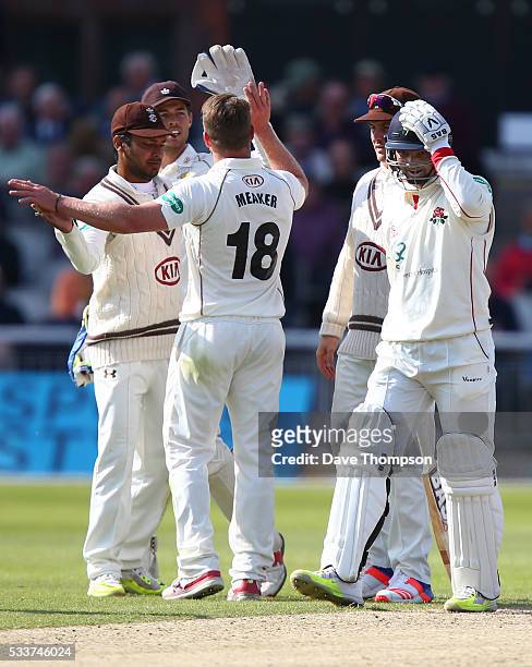 Alviro Petersen of Lancashire holds his head after being dismissed by Stuart Meaker of Surrey during the Specsavers County Championship Division One...