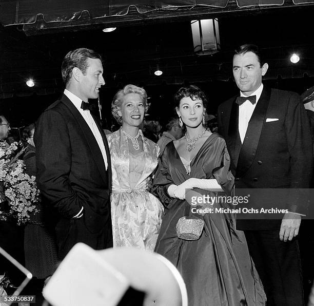 Actor Gregory Peck and his wife Veronique Passani with actor George Montgomery and singer Dinah Shore attend the premiere of "The Man in the Gray...