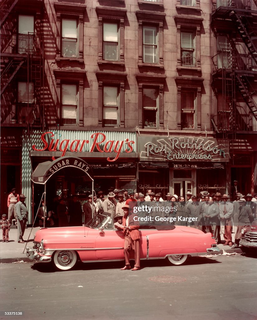 Boxer Sugar Ray Robinson leaning on his 1950 pink