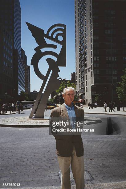American pop artist Roy Lichtenstein standing in front of his painted steel sculpture 'Modern Head', New York City, USA, circa 1996.