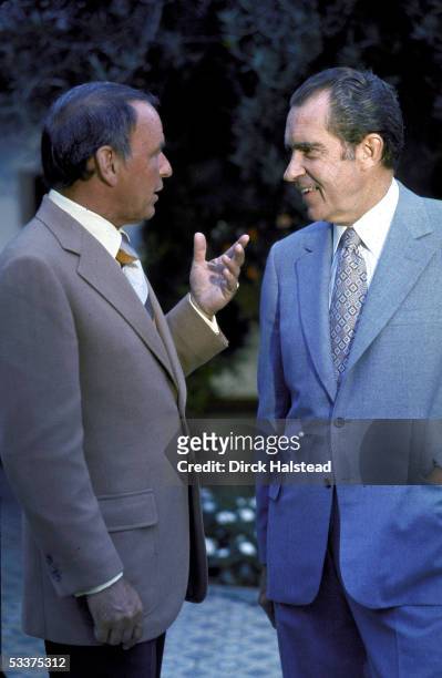 Entertainer Frank Sinatra chatting with President Richard Nixon at a GOP celebrity fundraising event at Nixon's home.