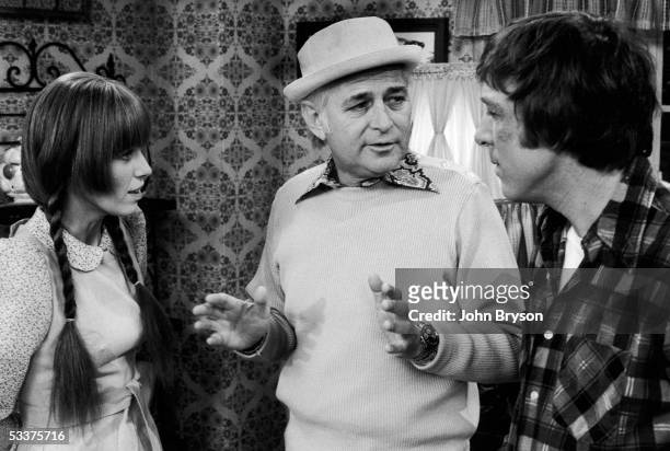 Norman Lear speaking with series star Louise Lasser and co-star Greg Mullavey on the set of TV show "Mary Hartman, Mary Hartman" in between takes.