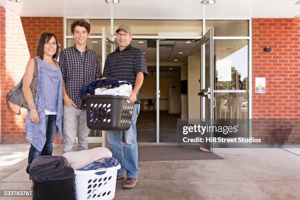 family helping college student son move into dormitory - day 1 stock pictures, royalty-free photos & images