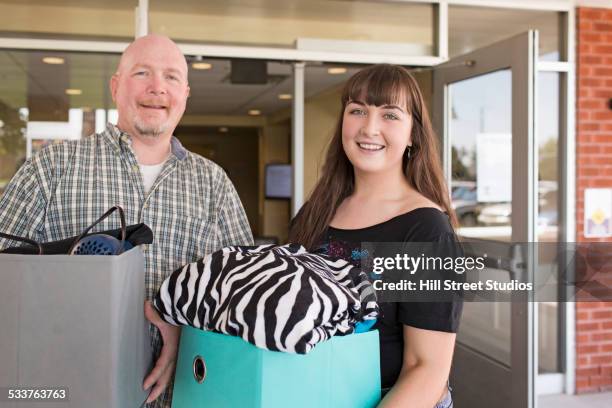 father helping college student daughter move into dormitory - opening day stock pictures, royalty-free photos & images