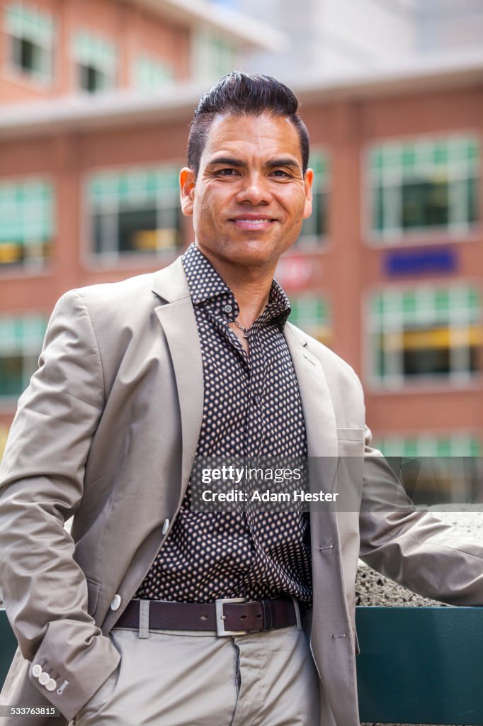 Hispanic businessman smiling outdoors