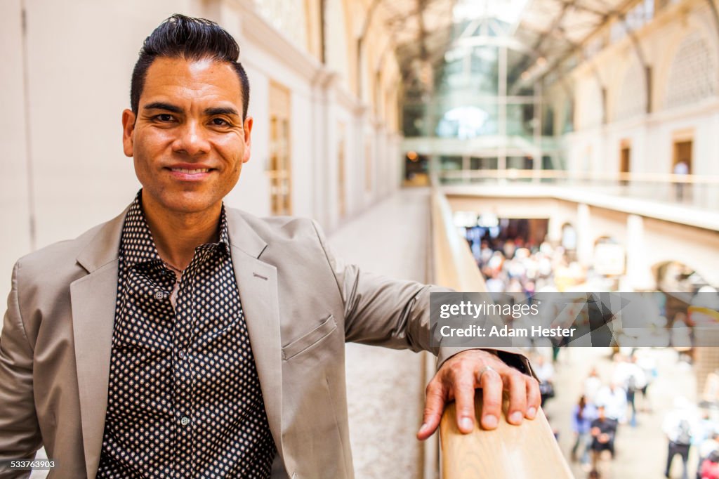 Hispanic businessman standing on upper level