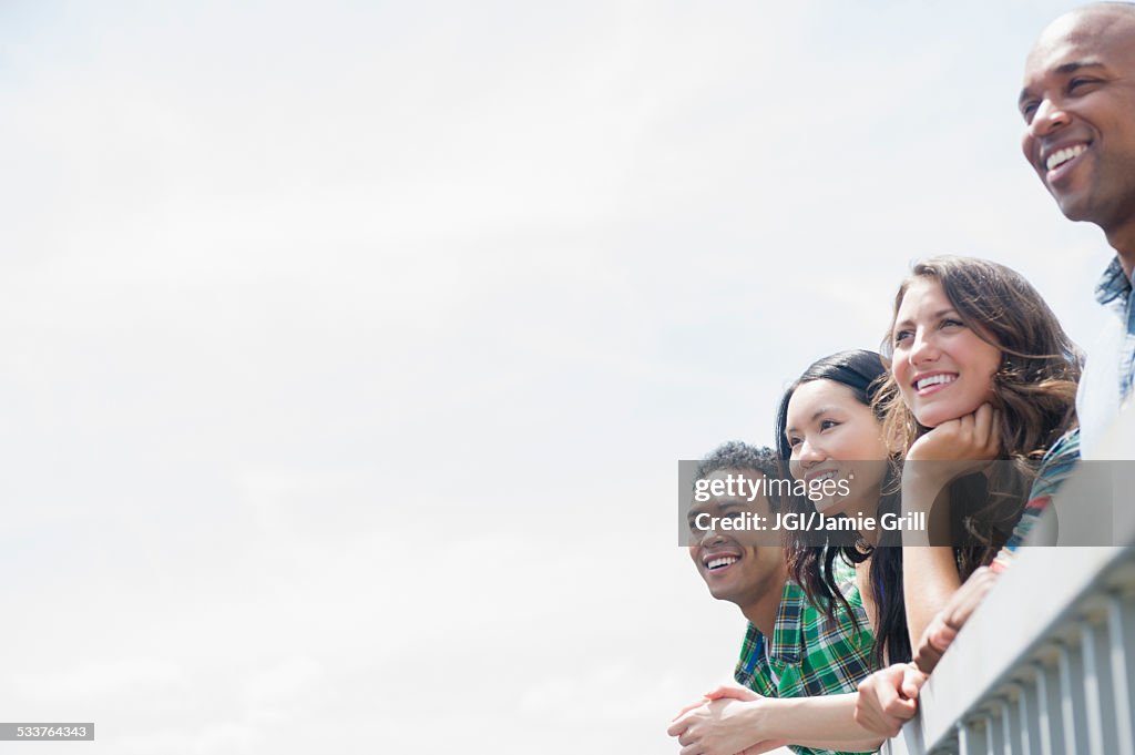 Friends admiring view from banister