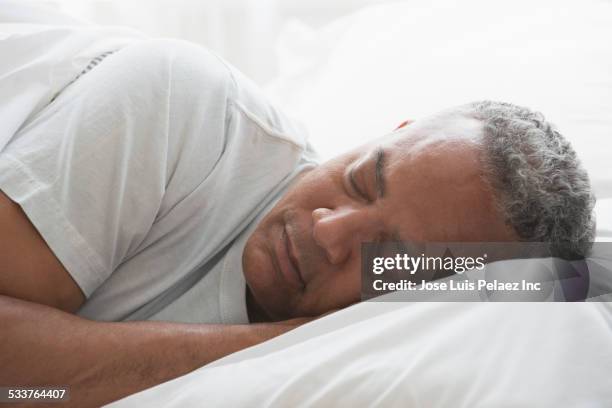 african american man sleeping in bed - black man sleeping in bed stock pictures, royalty-free photos & images