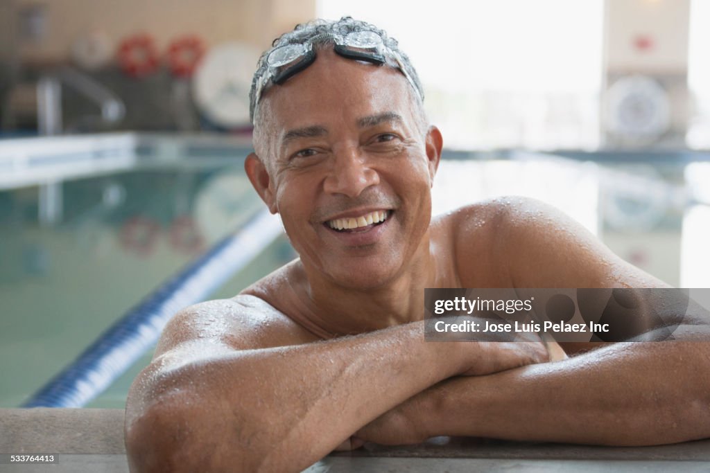 African American man wearing goggles in swimming pool