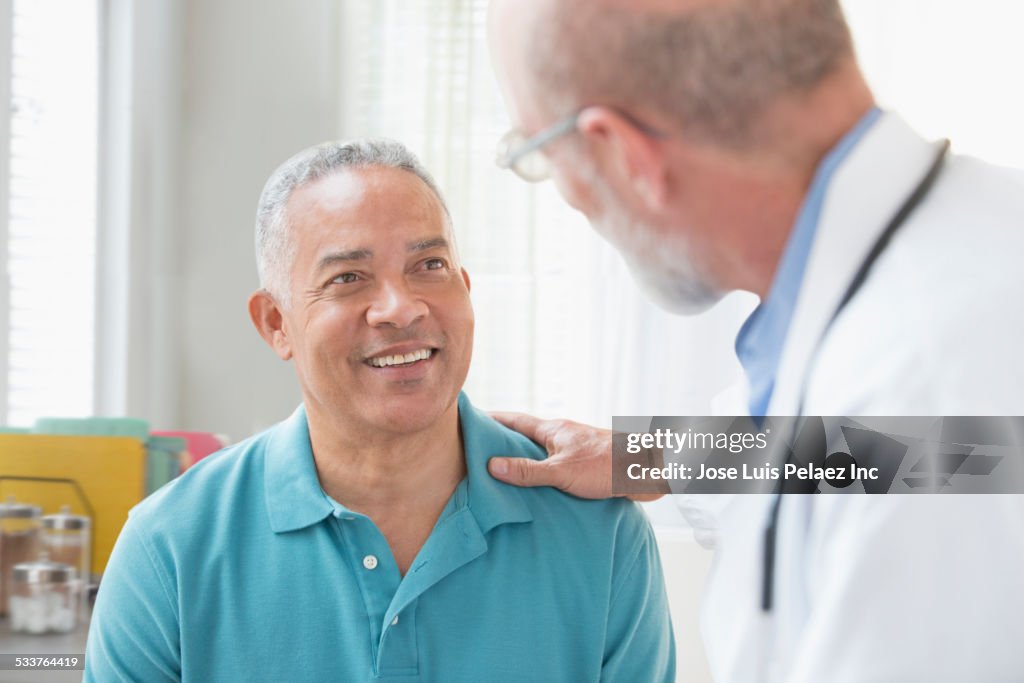 Doctor talking to patient in office