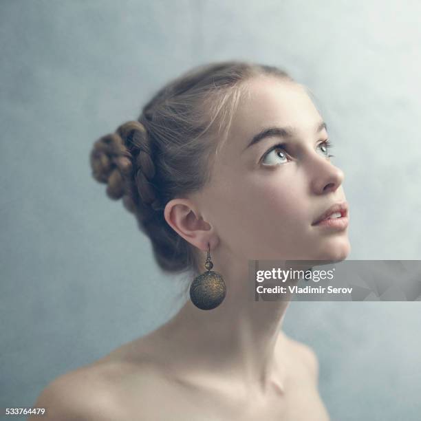 teenage girl with braided hair wearing dangling earrings - braided hair imagens e fotografias de stock