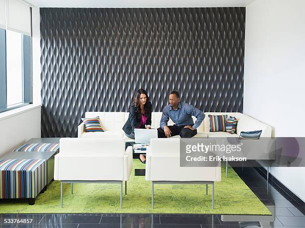 business people talking in office lobby - formal businesswear stock pictures, royalty-free photos & images