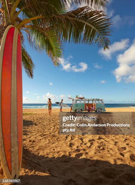 surfers unloading bus on tropical beach - honolulu beach stock pictures, royalty-free photos & images