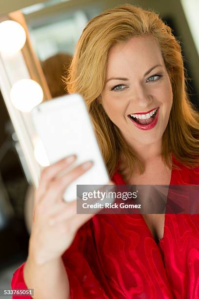 caucasian woman taking cell phone selfie - risque woman foto e immagini stock