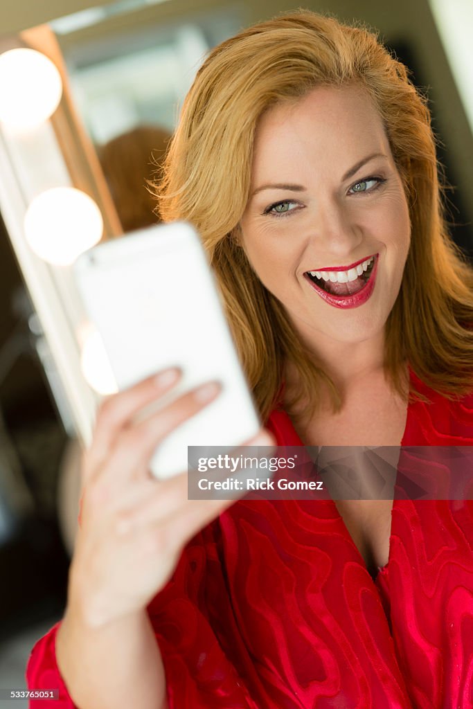 Caucasian woman taking cell phone selfie