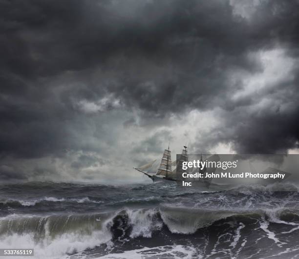 ship sailing on stormy seas - windjammer stock-fotos und bilder