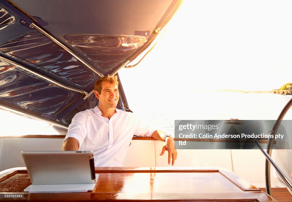 Caucasian man using digital tablet on yacht