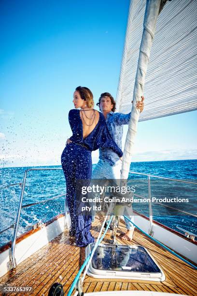 glamorous couple standing on yacht deck - glamour couple stock pictures, royalty-free photos & images