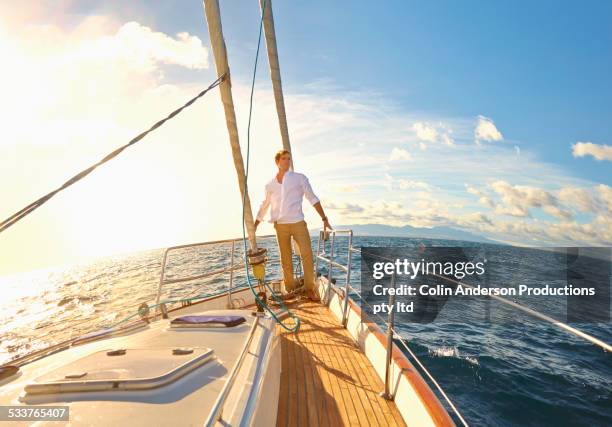 caucasian man standing on yacht deck - fish eye lens stock pictures, royalty-free photos & images