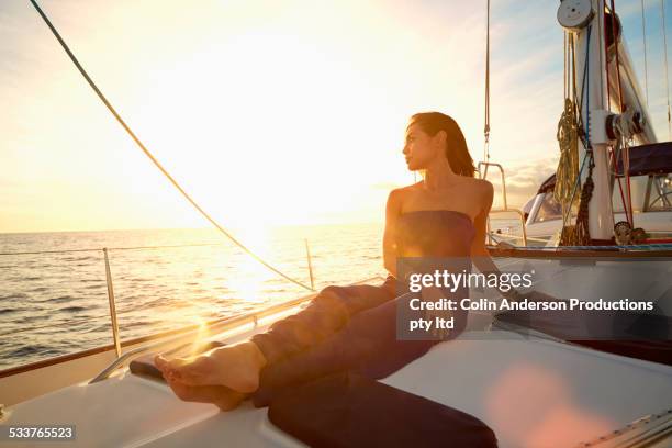 asian woman sitting on yacht deck - hot women on boats ストックフォトと画像