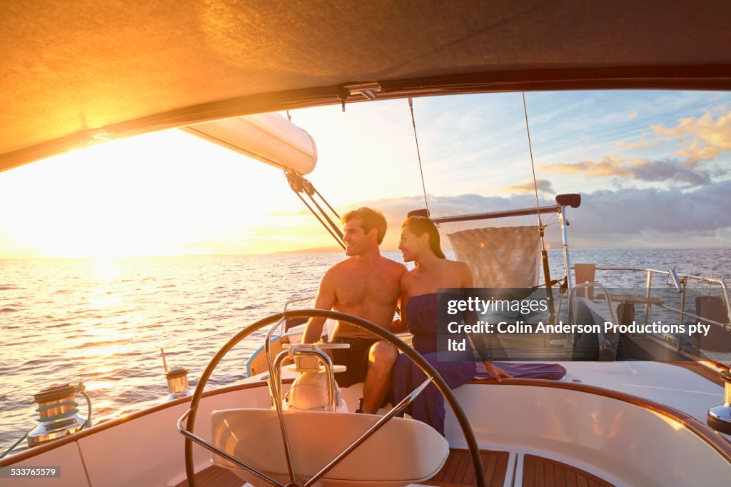 Couple steering yacht together