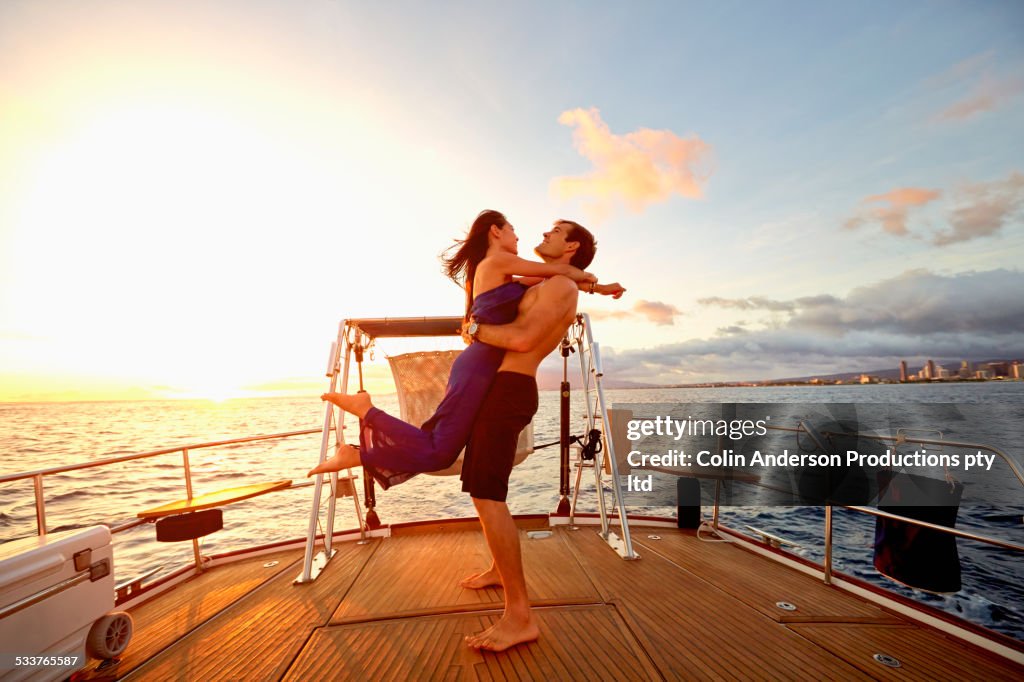 Couple playing on yacht deck