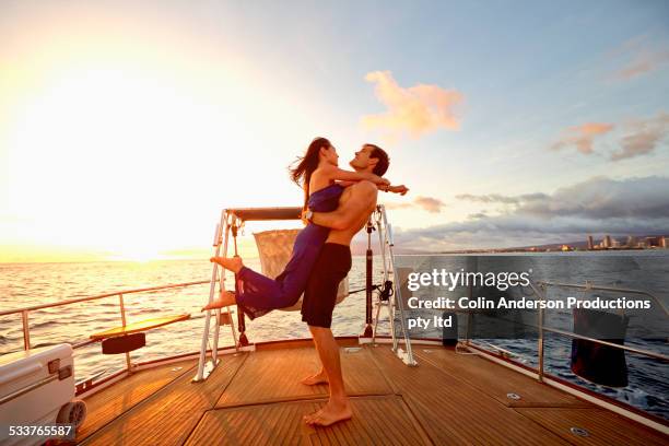 couple playing on yacht deck - hot women on boats ストックフォトと画像