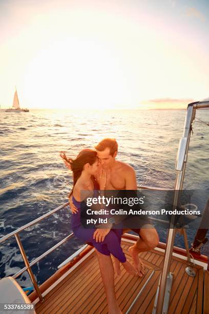 couple hugging on yacht deck - hot women on boats ストックフォトと画像