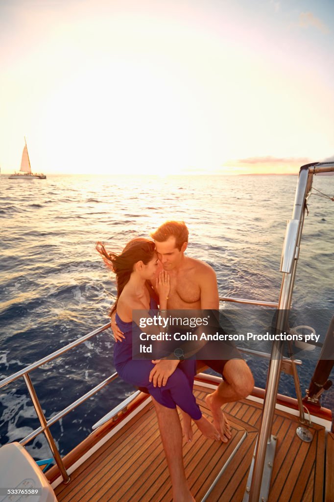 Couple hugging on yacht deck
