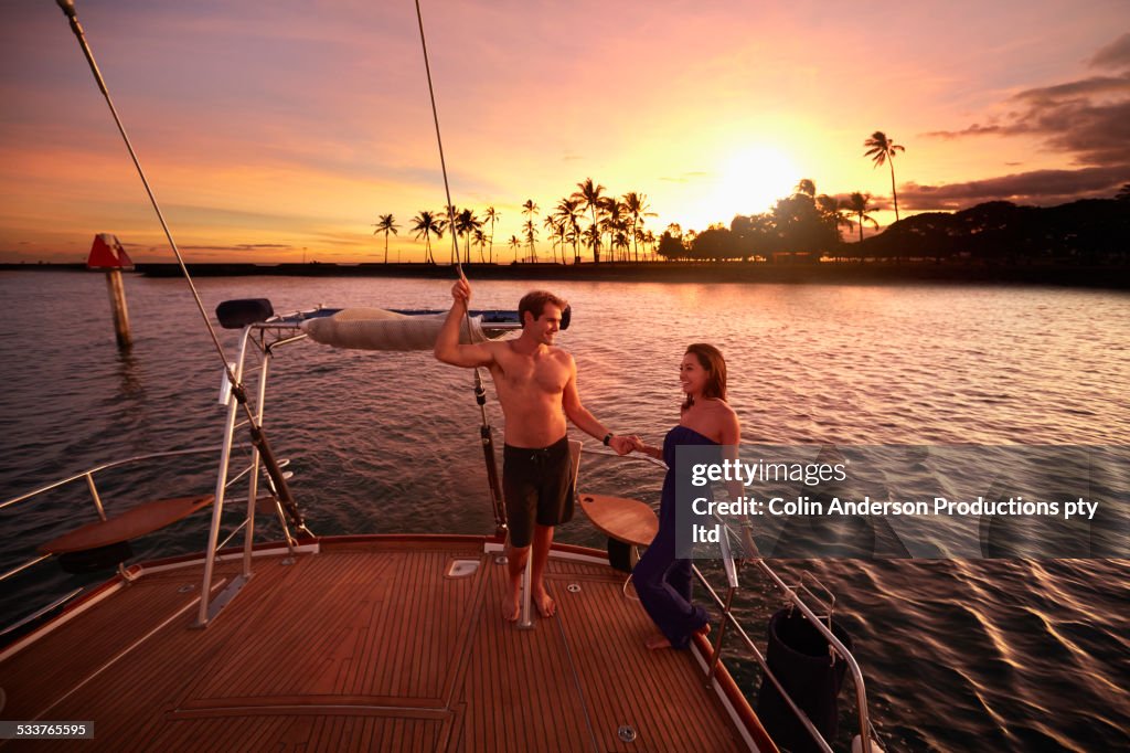 Couple holding hands on yacht deck