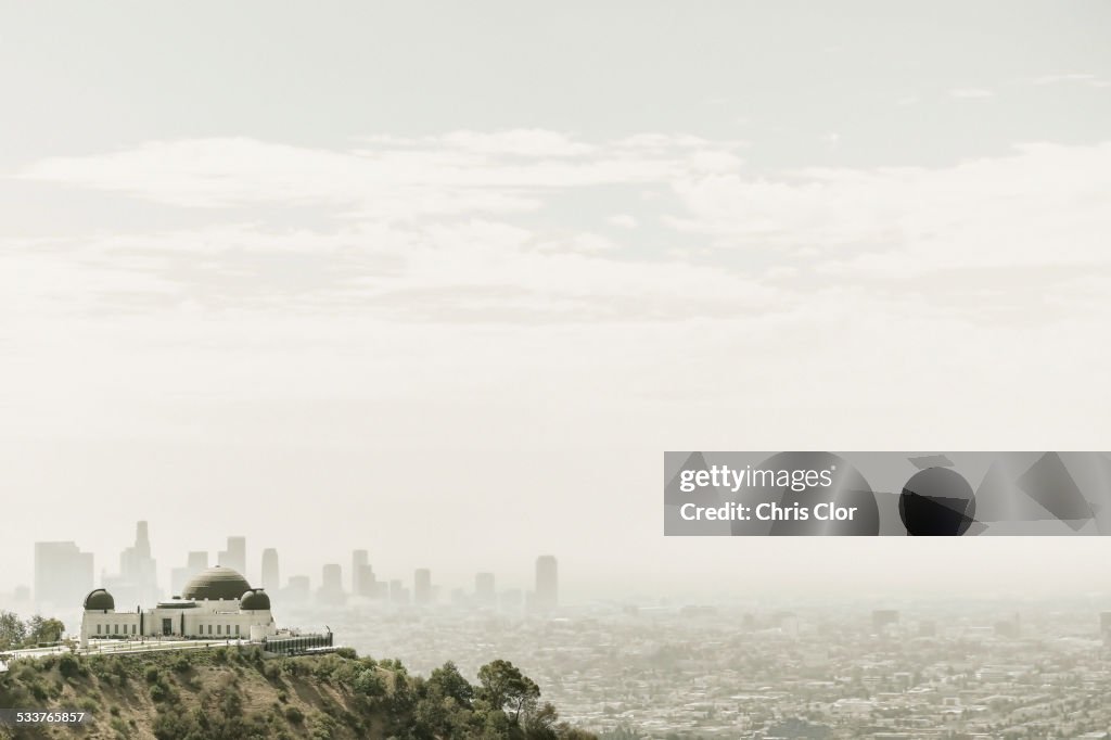 Observatory and city skyline in hazy sky, Los Angeles, California, United States