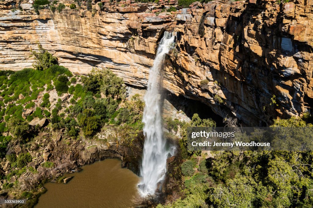 High angle view of waterfall flowing over rocky cliff