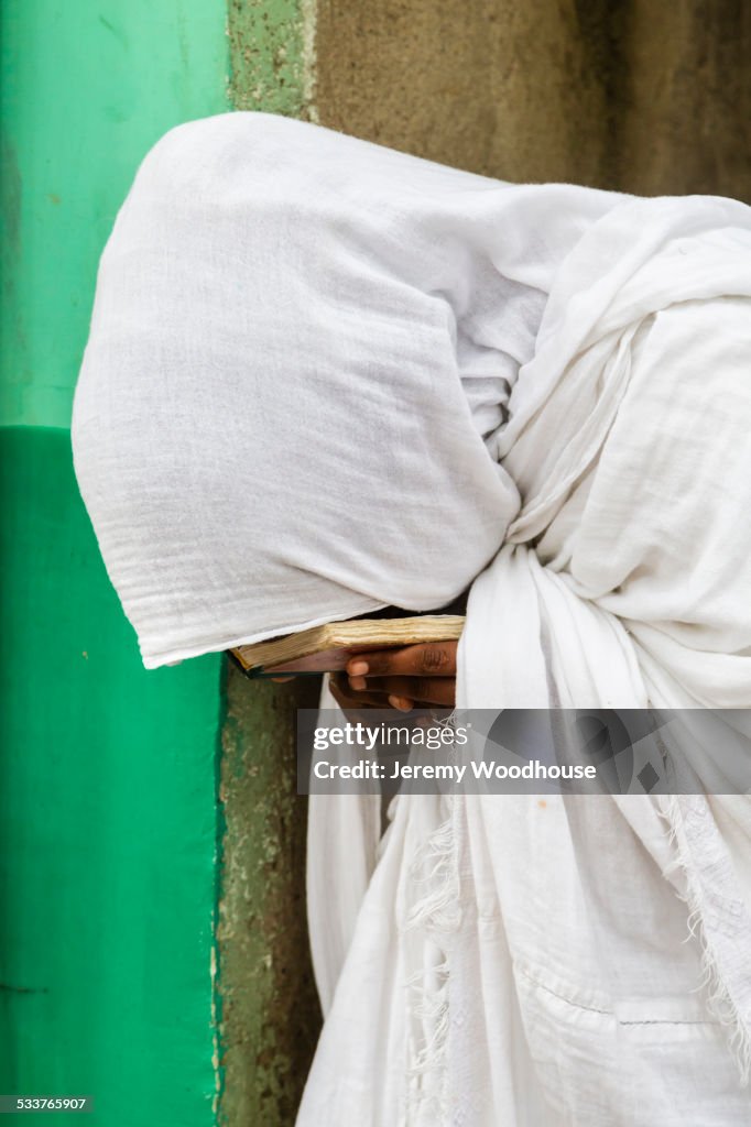 Close up of pilgrim praying in white robes
