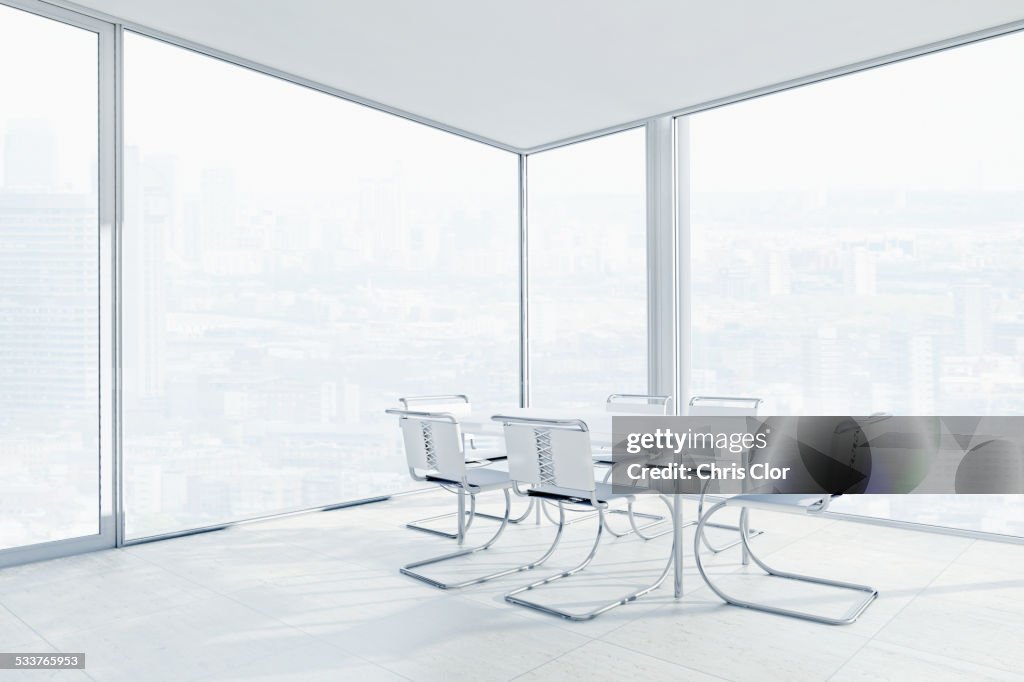 Empty chairs and conference table in office