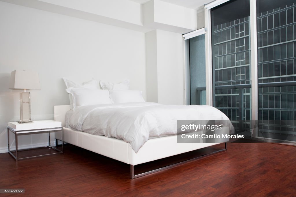 Bed, night table and closet in modern bedroom