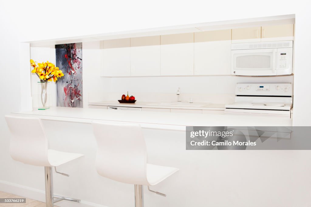 Stools and breakfast bar in modern kitchen