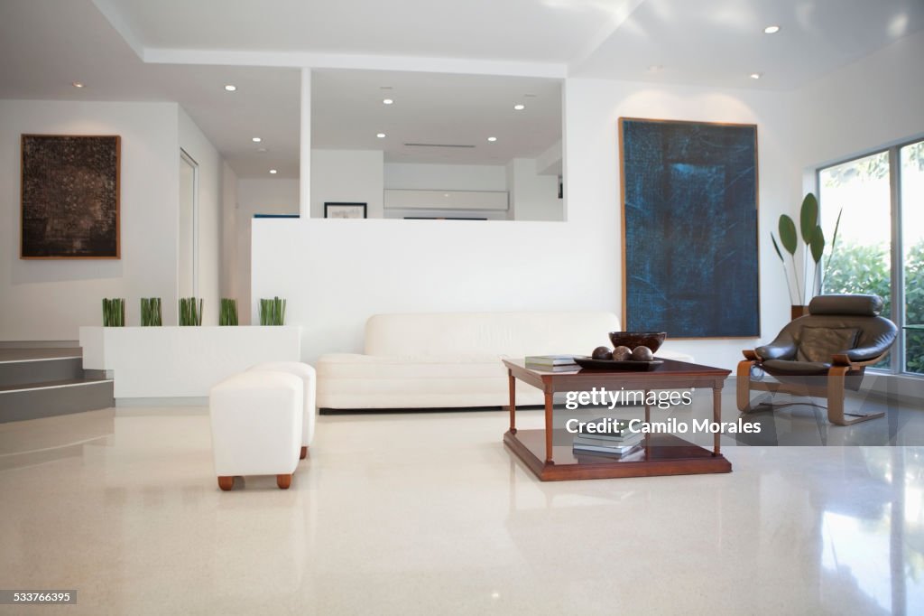 Coffee table, chairs and walls in modern living space