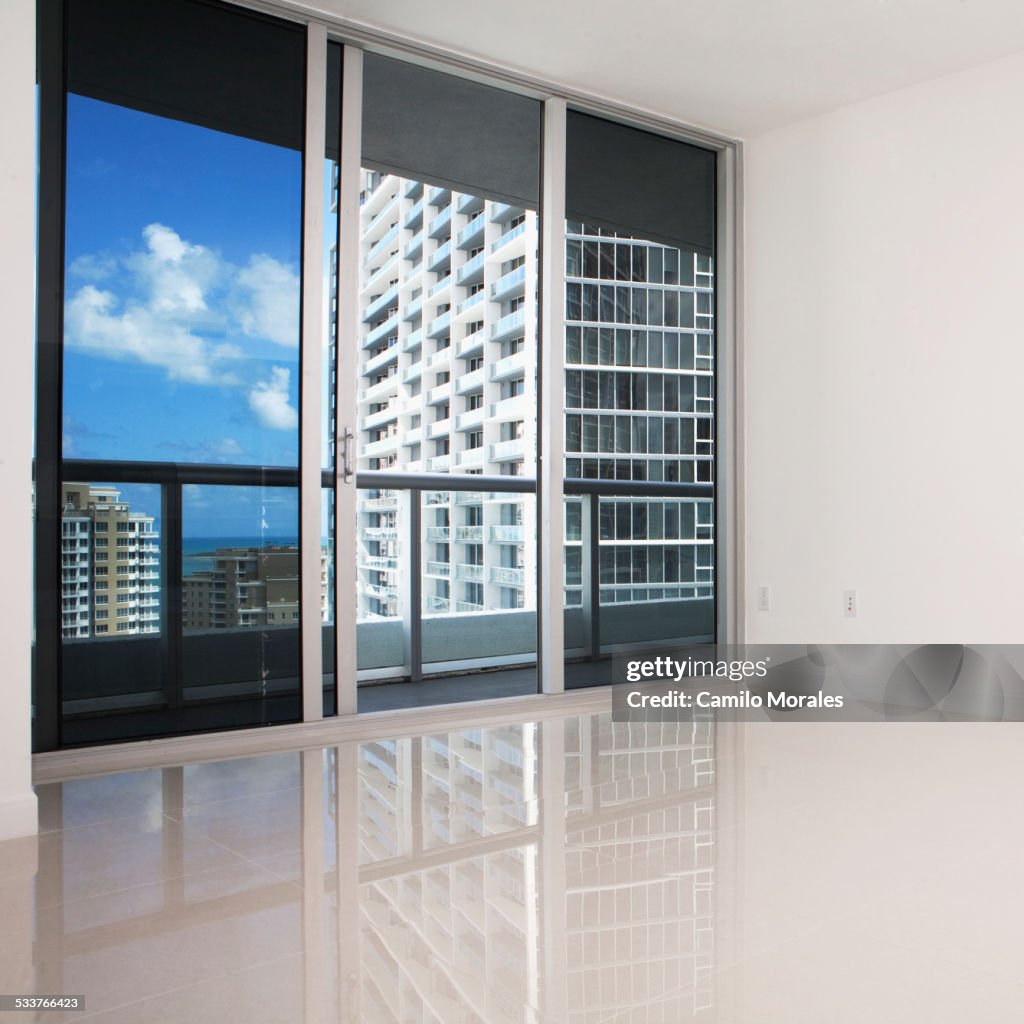 Glass doors and balcony of empty modern apartment