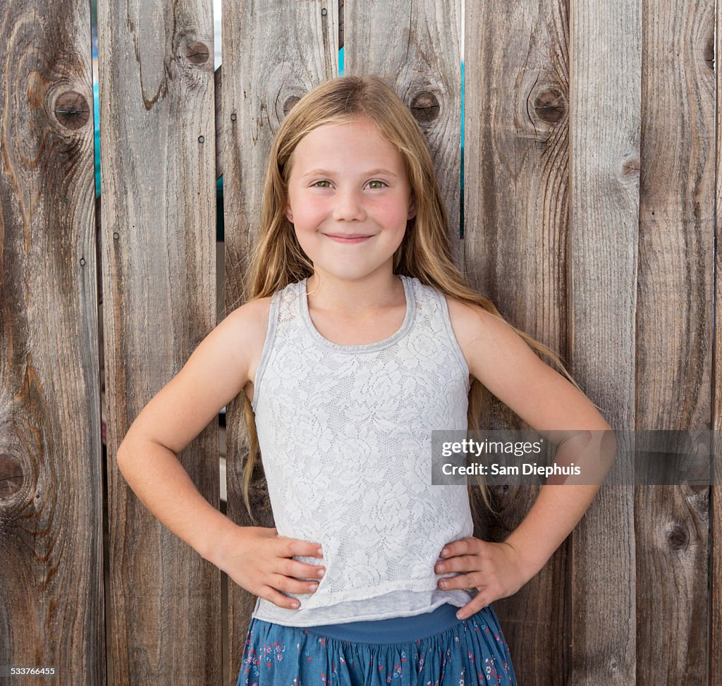 Caucasian girl smiling with hands on hips